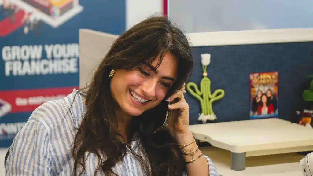 Ava on the phone with a client